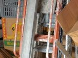 boxes and ladders are stacked on top of each other in a garage
