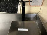an image of a scale sitting on top of a metal counter