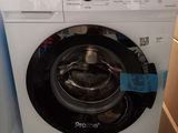 a washing machine that is in the corner of a room