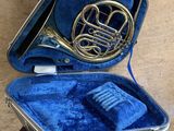 a silver and blue case with a horn inside of it