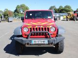 a red jeep that is parked in a parking lot