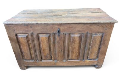 un vieux coffre en bois posé sur une surface blanche