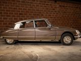 a brown car parked in a garage next to a brick wall