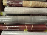 many rolls of wrapping paper in a cardboard box