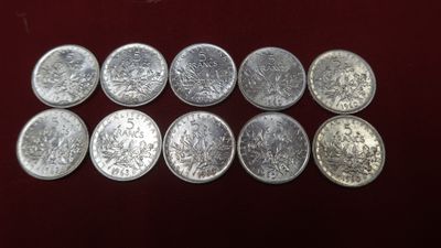 a close up of a bunch of silver coins on a table