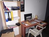 a desk with a chair and a computer on it