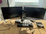 two computer monitors and a keyboard on a desk