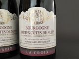 two bottles of wine sitting next to each other on a table