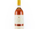 the bottle of wine is sitting on a white surface