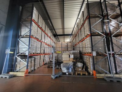a large warehouse filled with lots of boxes and pallets