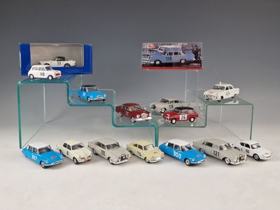 a lot of toy cars that are on a glass shelf