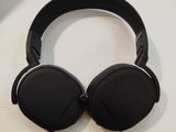 the black headphones are sitting on a white surface