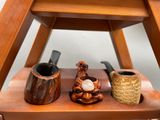 three different types of pipe holders on a shelf