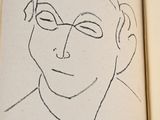 an open book with a drawing of a man ' s face on it