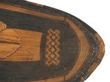 a close up of a woven boat on a white surface