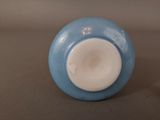 a blue and white vase sitting on a table