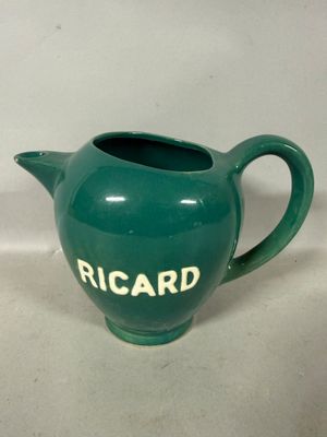 a green teapot with the word ricard written on it
