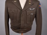 an army uniform on a mannequin stand on a grey background