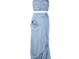 a dress on a mannequin stand with a white background