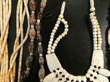 several necklaces and bracelets are laid out on a black surface