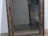 a mirror that is sitting on the floor next to a wall