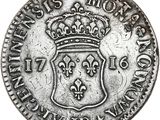 a silver coin with a crown on top of it
