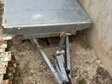 a metal table that is sitting in the dirt