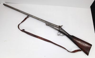 un vieux pistolet avec une crosse en bois et une lanière en cuir