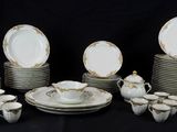 a lot of plates and cups on a black table