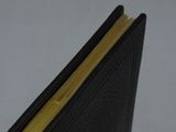 a close up of a black leather wallet with a yellow strip