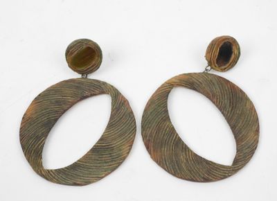 pair of large wooden earrings with a circular design and a wooden bead
