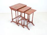three wooden nesting tables sitting on top of a white floor