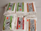 several bags of rice sitting on top of a white counter