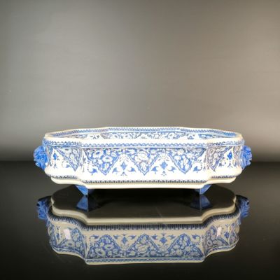 a blue and white bowl sitting on a black table