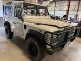 a picture of a white land rover parked in a garage