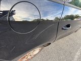 a black car with a hole in the side door