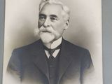 portrait of a man in a suit and tie with a mustache