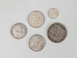 four different types of coins are shown on a white surface