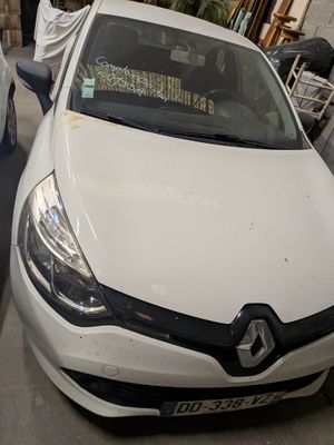 a white car that is parked on the side of the street