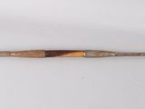 an old baseball bat sitting on top of a white table