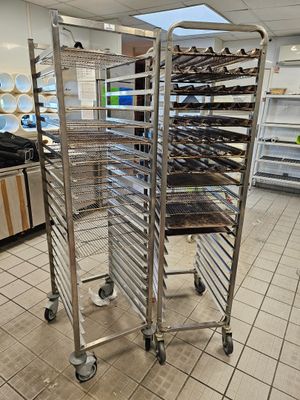 many trays of food that are on the rack in the kitchen