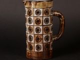 a brown and white coffee mug with a pattern on it