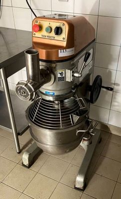 a mixer that is sitting on a stand in a kitchen