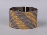 a close up of a bracelet with a yellow and grey design