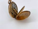 an antique pocket watch with a chain attached to it ' s face