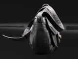 a close up of a black purse on a black surface