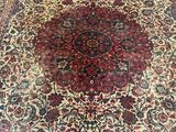 a close up of a large oriental rug on a wooden floor