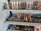 a lot of makeup products on the shelves in the store