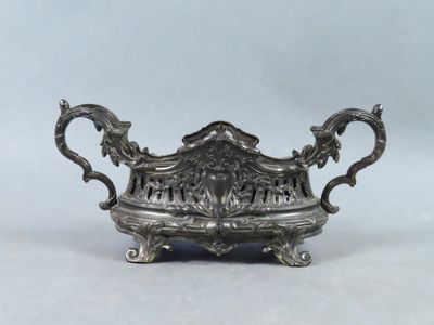 an antique silver plate with ornate design on it