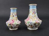 pair of vases with floral designs on them on a black background